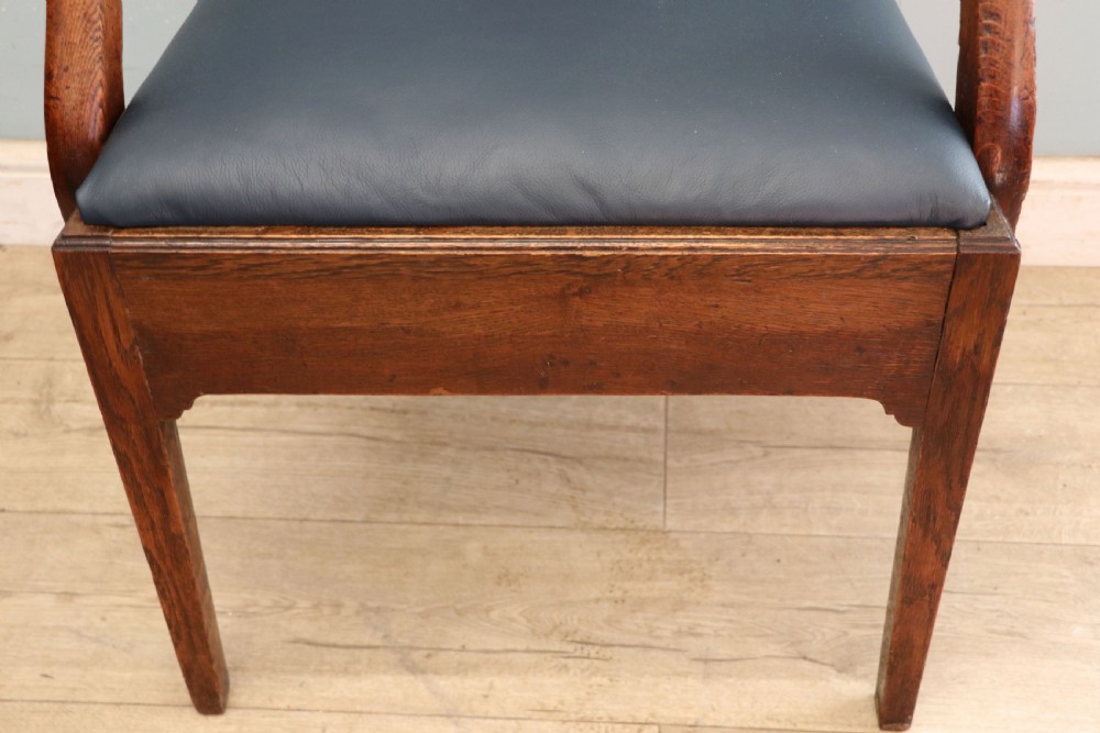 A pair of early 19th century dark timber carver chairs featuring open pierced splats, swept armrests, and dark upholstered seats. View XXIII