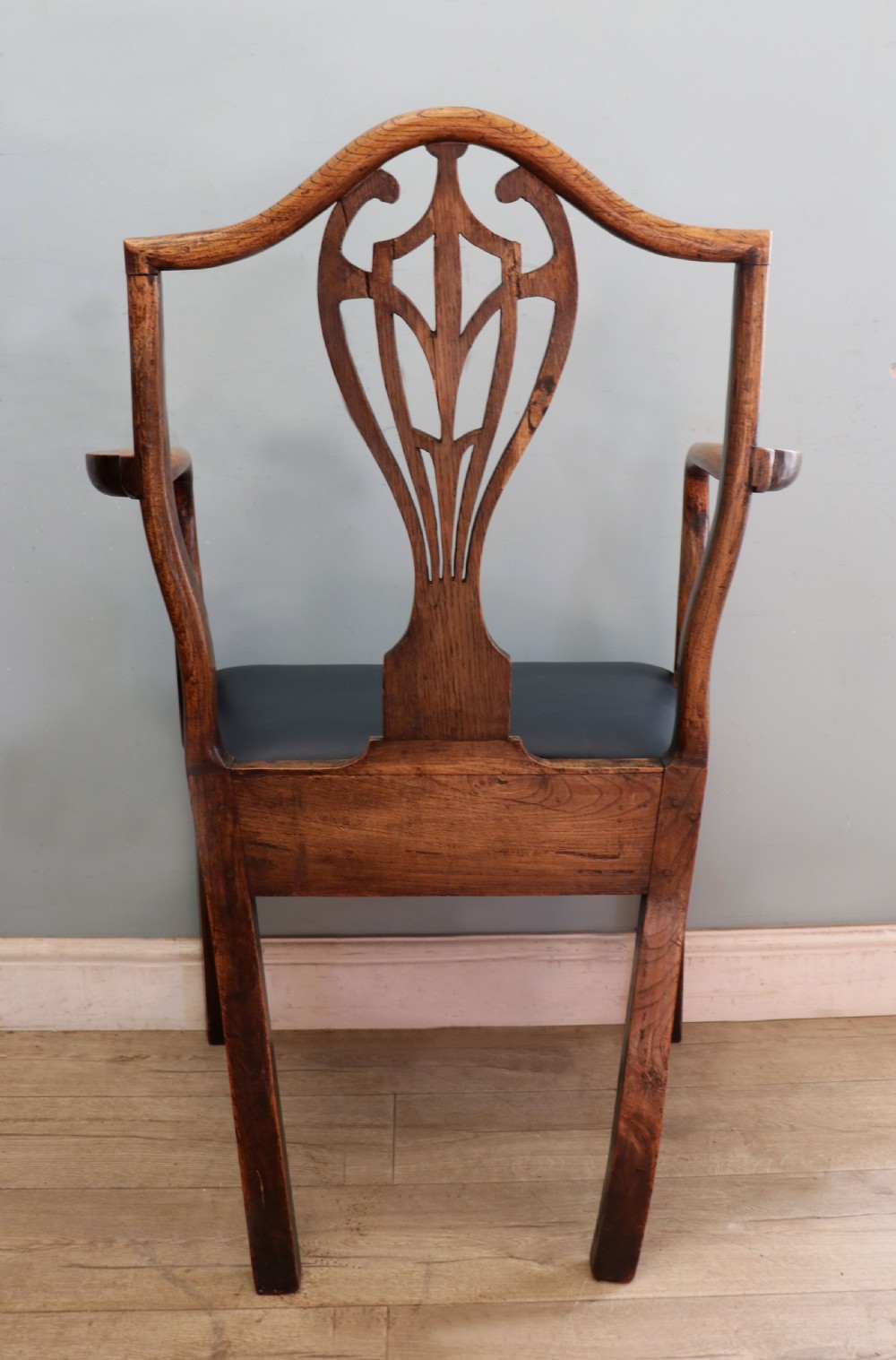 A pair of early 19th century dark timber carver chairs featuring open pierced splats, swept armrests, and dark upholstered seats. View XXIX
