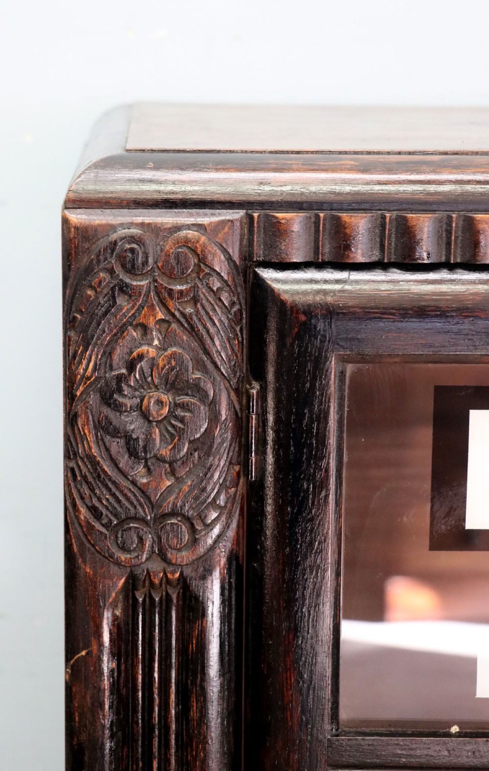 A dark oak glazed cabinet featuring hand-painted white lettering for the British Broadcasting Company across two glass doors. View XX