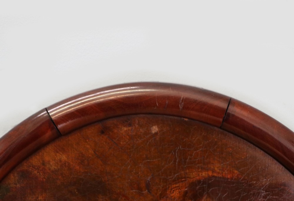 A tall, arched 19th-century mahogany wall mirror featuring an upper oil painting of childrens faces above a rectangular mirror glass. View III