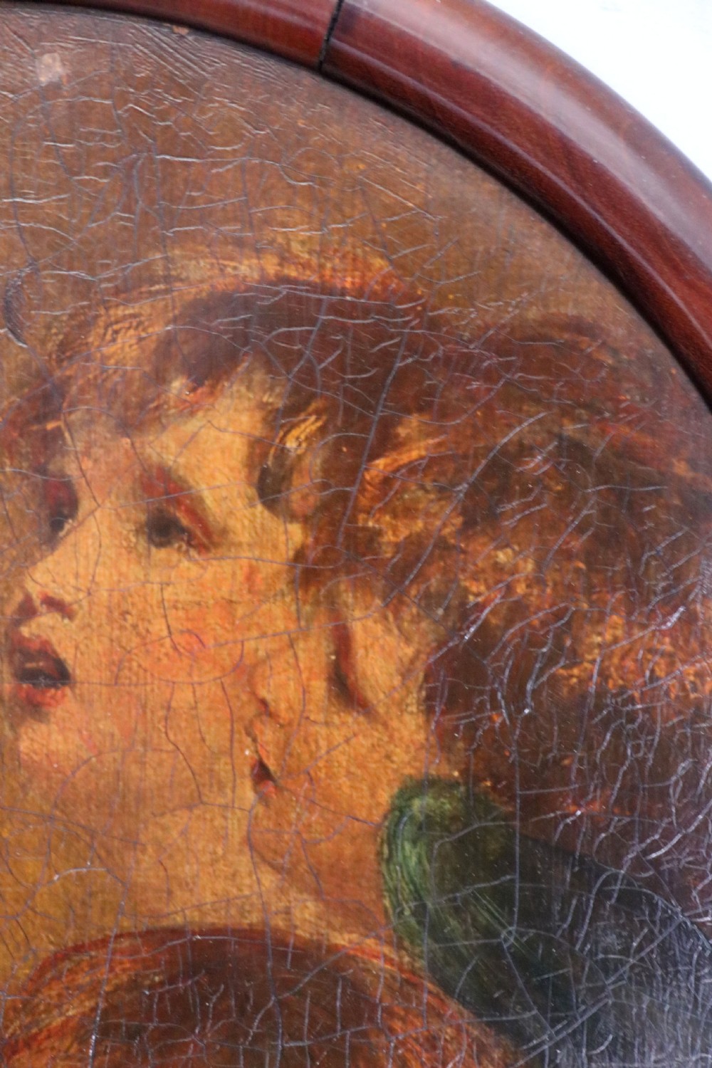 A tall, arched 19th-century mahogany wall mirror featuring an upper oil painting of childrens faces above a rectangular mirror glass. View VIII