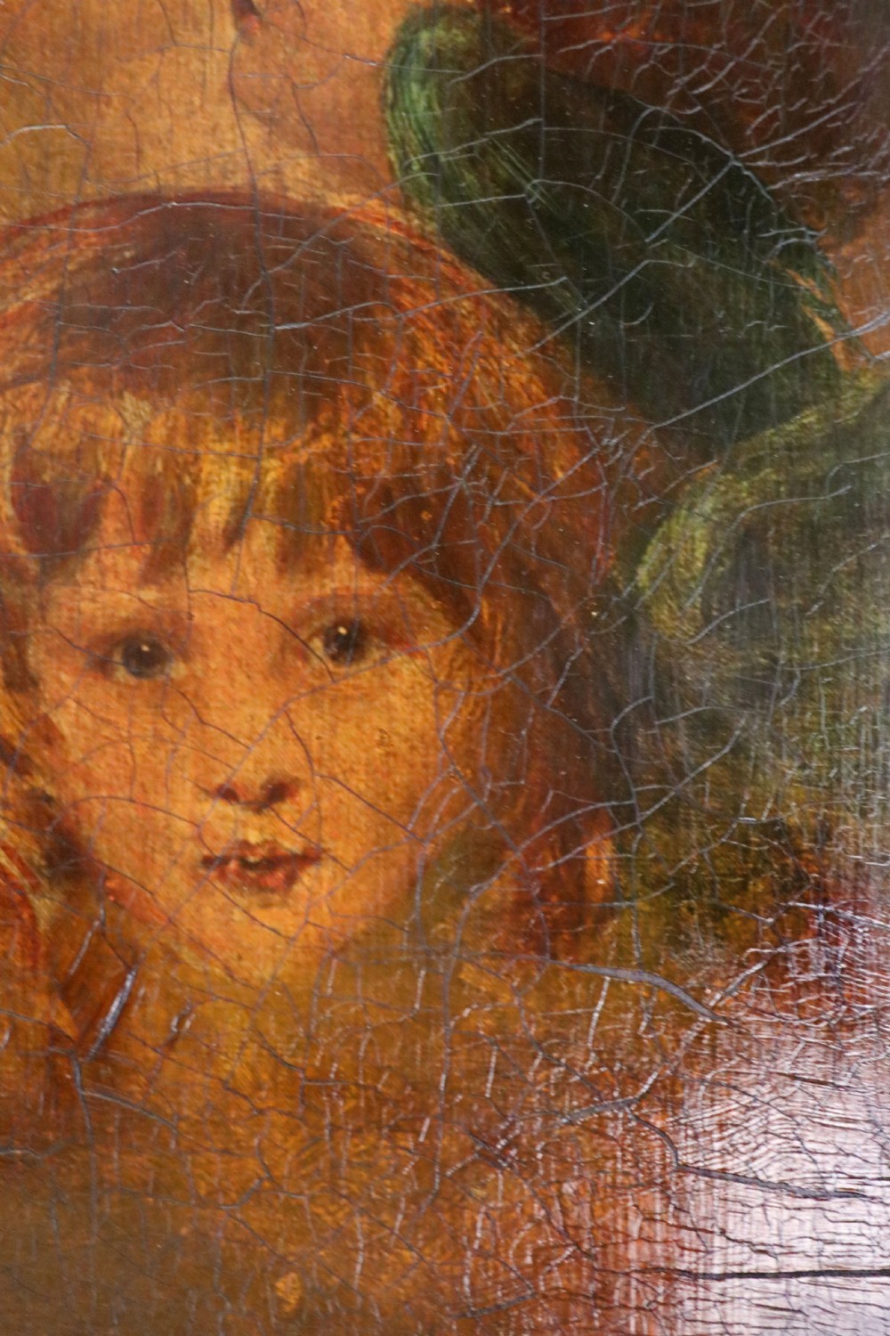 A tall, arched 19th-century mahogany wall mirror featuring an upper oil painting of childrens faces above a rectangular mirror glass. View IX