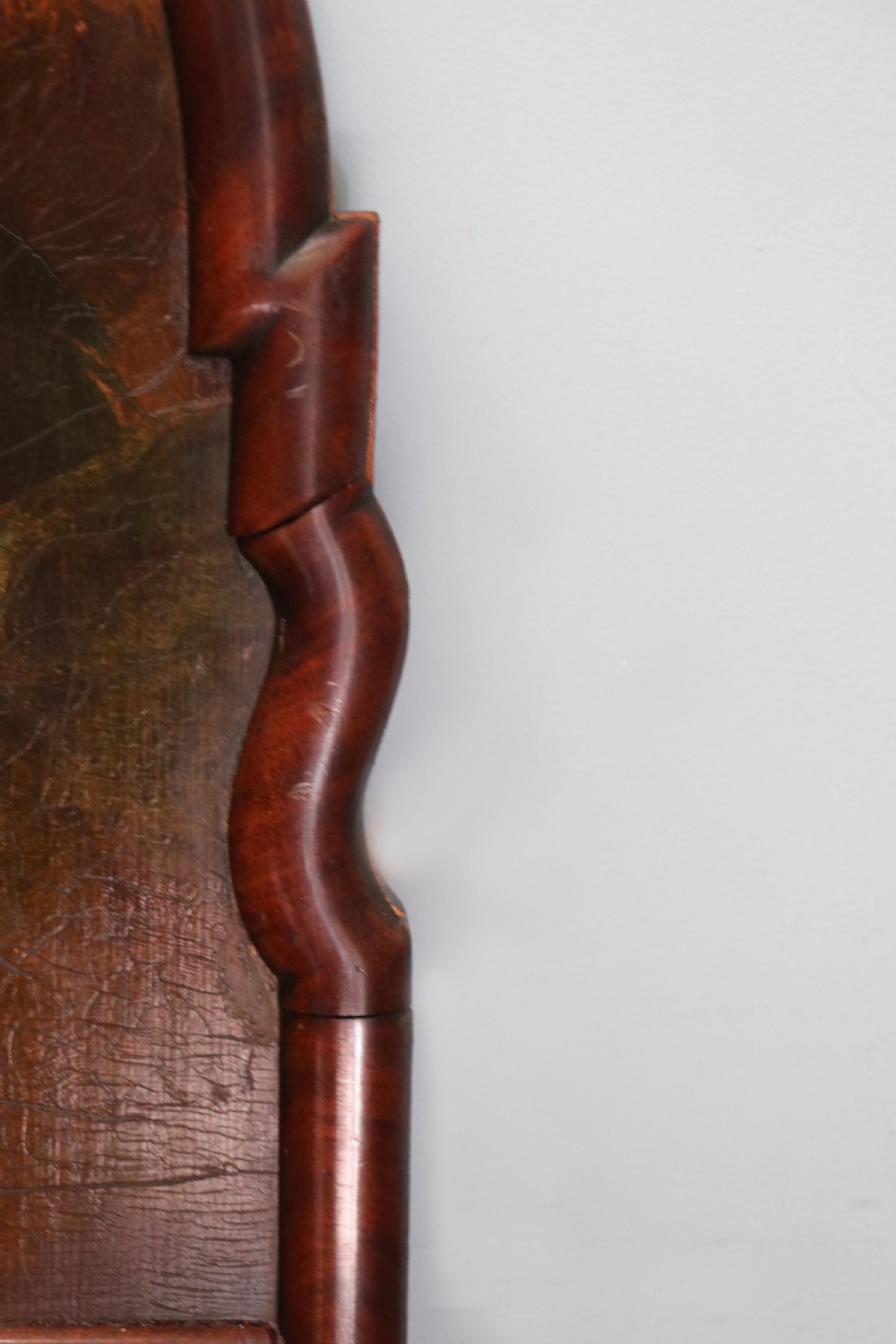A tall, arched 19th-century mahogany wall mirror featuring an upper oil painting of childrens faces above a rectangular mirror glass. View X