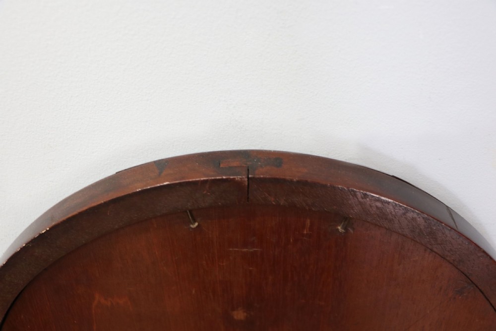 A tall, arched 19th-century mahogany wall mirror featuring an upper oil painting of childrens faces above a rectangular mirror glass. View XII