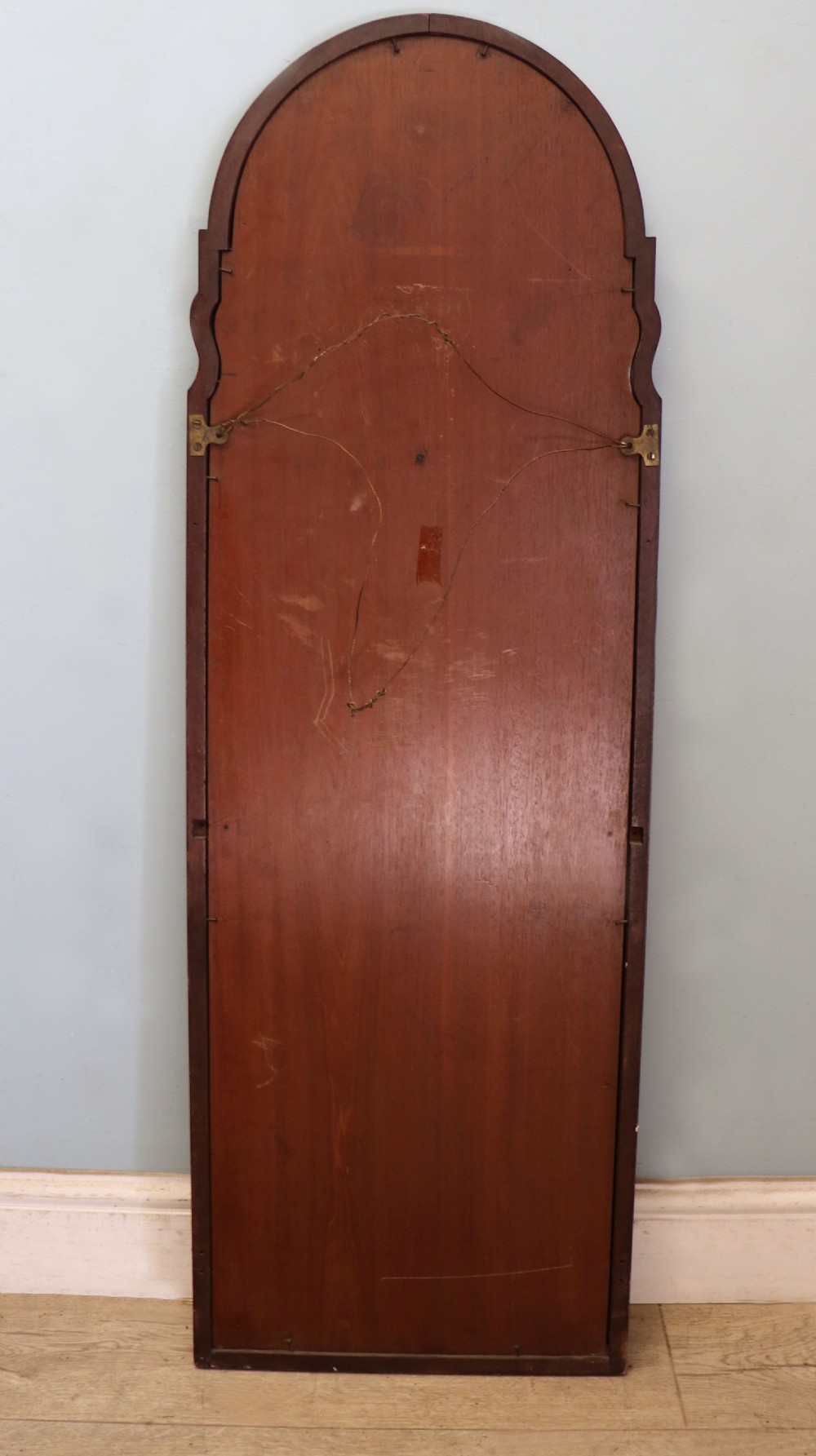 A tall, arched 19th-century mahogany wall mirror featuring an upper oil painting of childrens faces above a rectangular mirror glass. View XIII