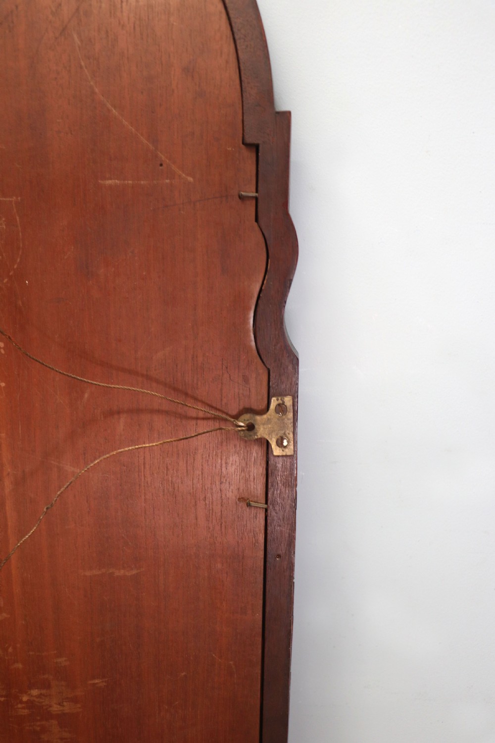 A tall, arched 19th-century mahogany wall mirror featuring an upper oil painting of childrens faces above a rectangular mirror glass. View XIV