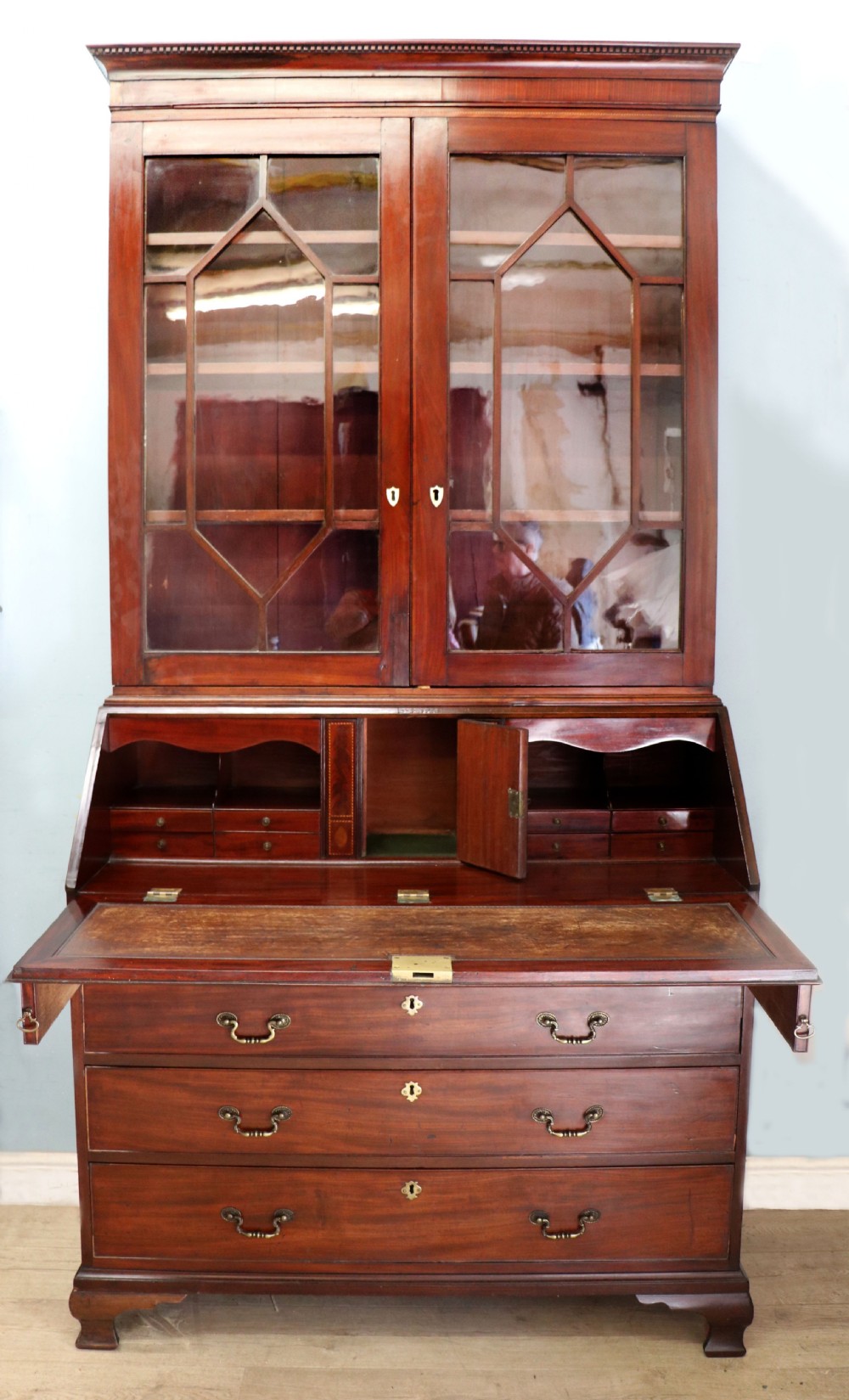 Late eighteenth-century mahogany bureau bookcase with an upper glazed cabinet featuring geometric astragal bars, an open fall-front writing surface, and lower drawers with brass handles. View II