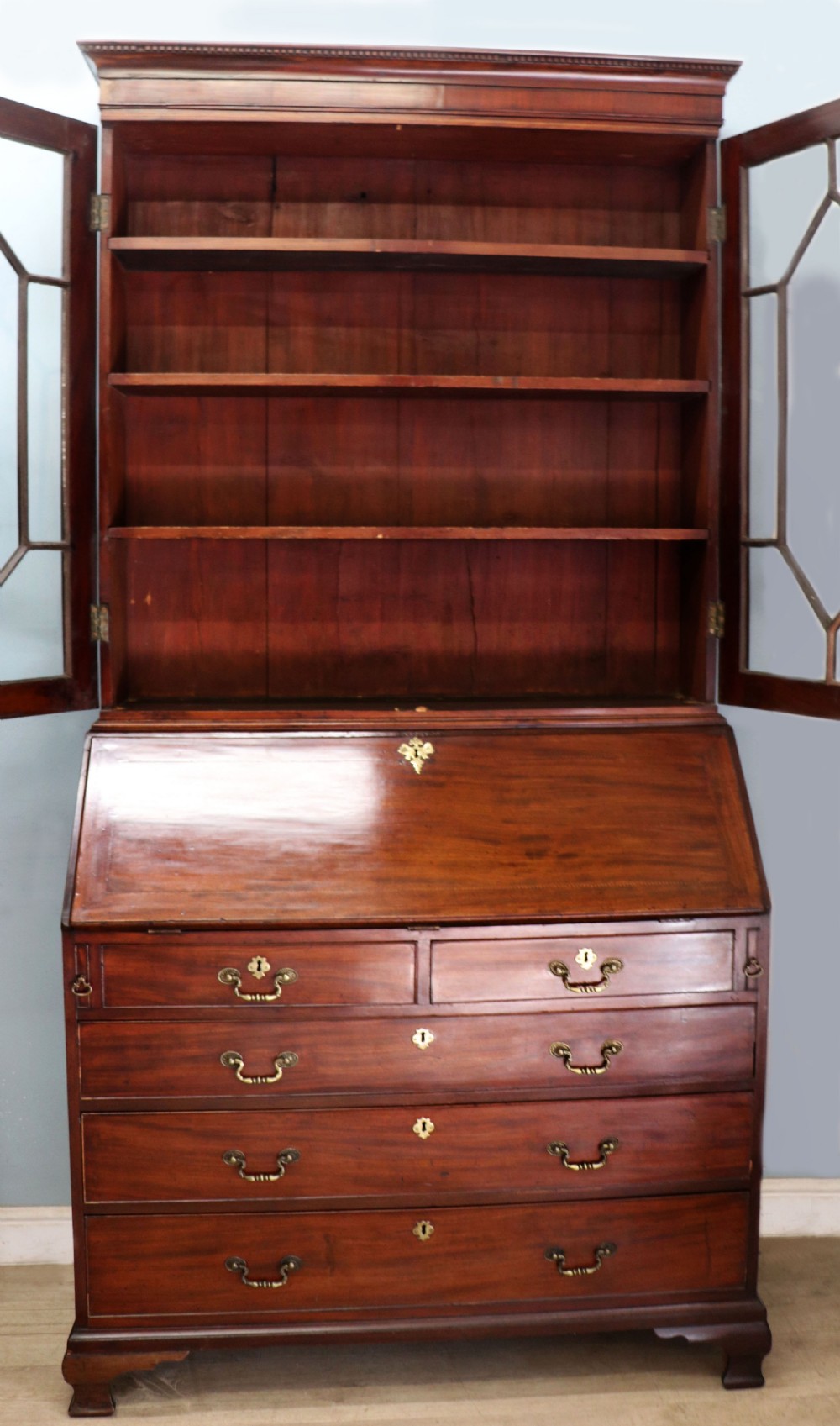 Late eighteenth-century mahogany bureau bookcase with an upper glazed cabinet featuring geometric astragal bars, an open fall-front writing surface, and lower drawers with brass handles. View IV