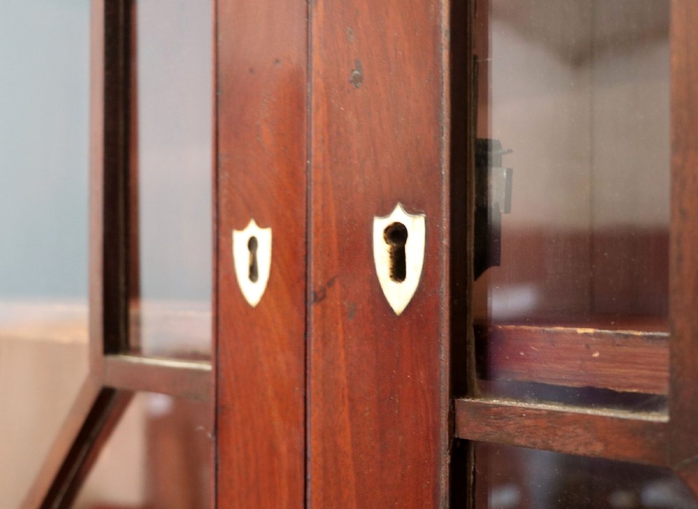 Late eighteenth-century mahogany bureau bookcase with an upper glazed cabinet featuring geometric astragal bars, an open fall-front writing surface, and lower drawers with brass handles. View XIV