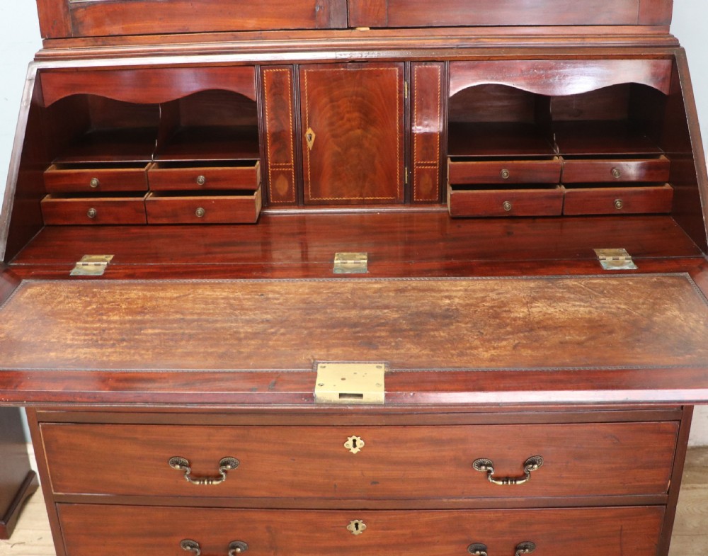Late eighteenth-century mahogany bureau bookcase with an upper glazed cabinet featuring geometric astragal bars, an open fall-front writing surface, and lower drawers with brass handles. View XV