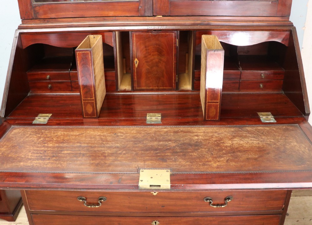 Late eighteenth-century mahogany bureau bookcase with an upper glazed cabinet featuring geometric astragal bars, an open fall-front writing surface, and lower drawers with brass handles. View XVI