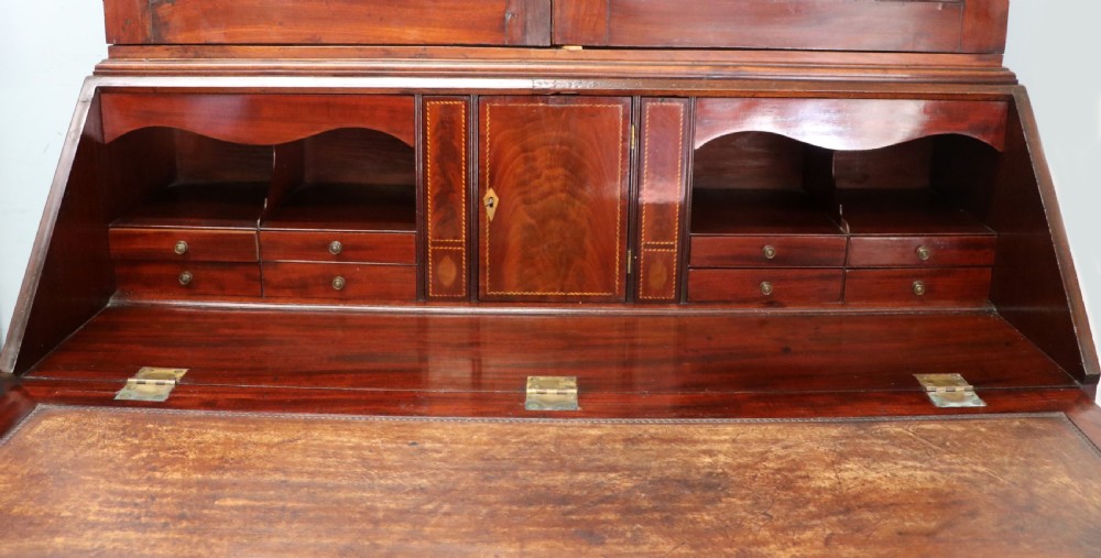 Late eighteenth-century mahogany bureau bookcase with an upper glazed cabinet featuring geometric astragal bars, an open fall-front writing surface, and lower drawers with brass handles. View XVII