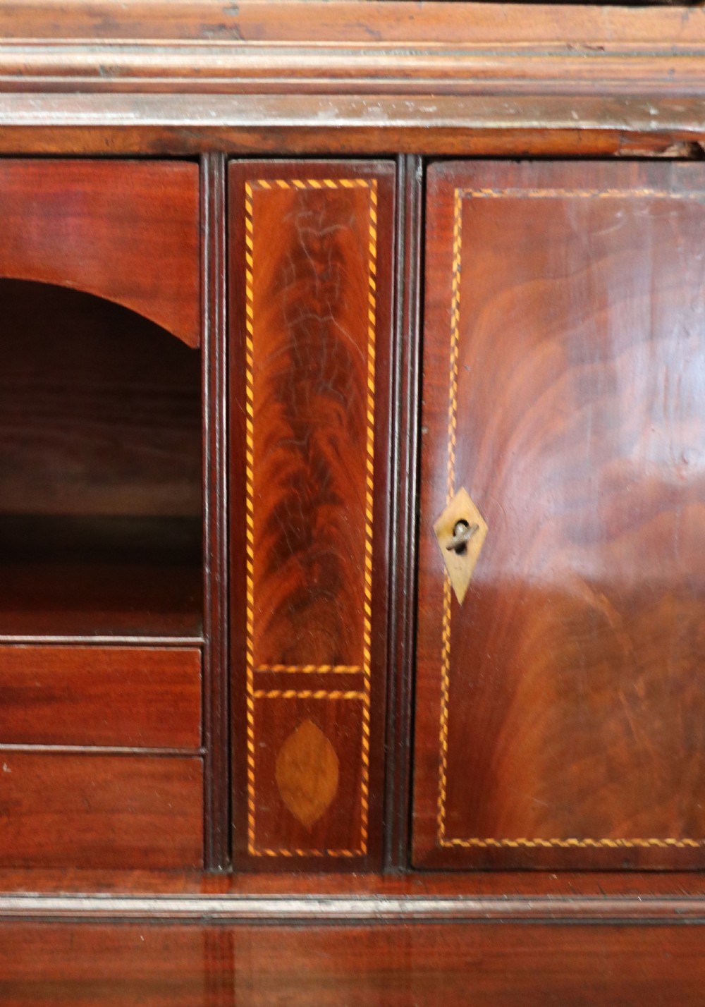 Late eighteenth-century mahogany bureau bookcase with an upper glazed cabinet featuring geometric astragal bars, an open fall-front writing surface, and lower drawers with brass handles. View XVIII