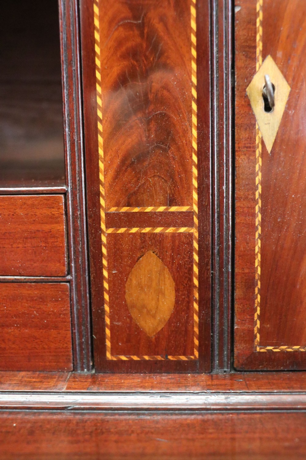 Late eighteenth-century mahogany bureau bookcase with an upper glazed cabinet featuring geometric astragal bars, an open fall-front writing surface, and lower drawers with brass handles. View XIX