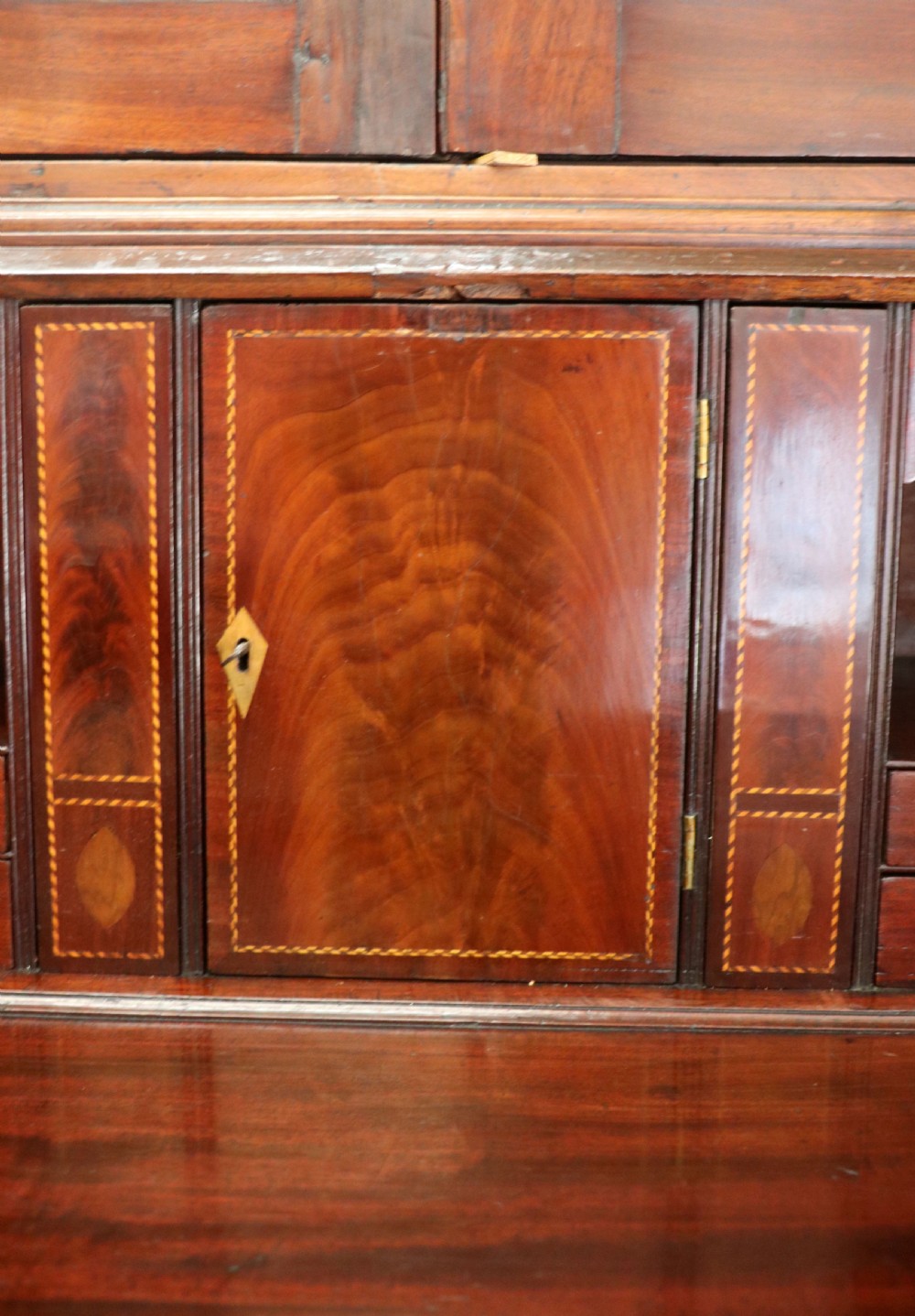 Late eighteenth-century mahogany bureau bookcase with an upper glazed cabinet featuring geometric astragal bars, an open fall-front writing surface, and lower drawers with brass handles. View XX