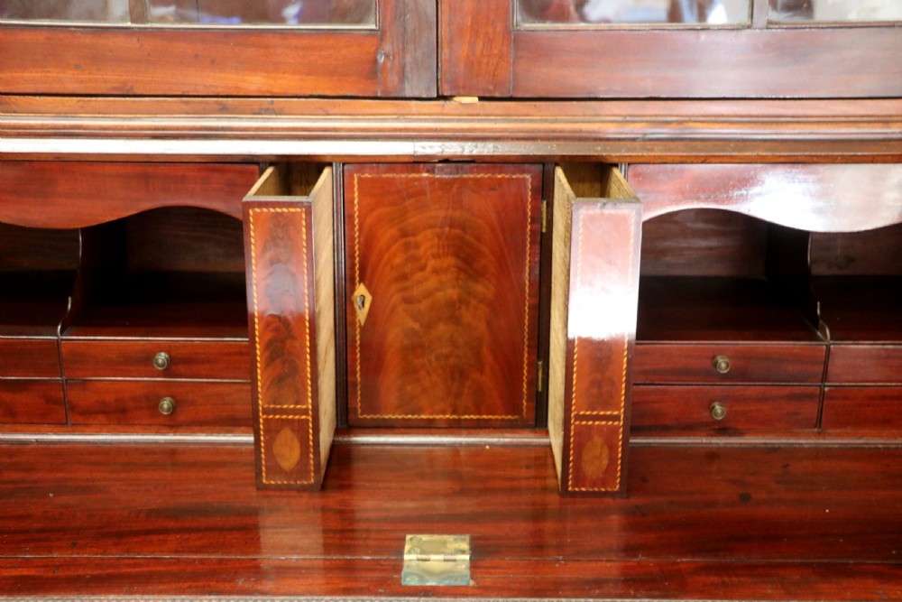 Late eighteenth-century mahogany bureau bookcase with an upper glazed cabinet featuring geometric astragal bars, an open fall-front writing surface, and lower drawers with brass handles. View XXII