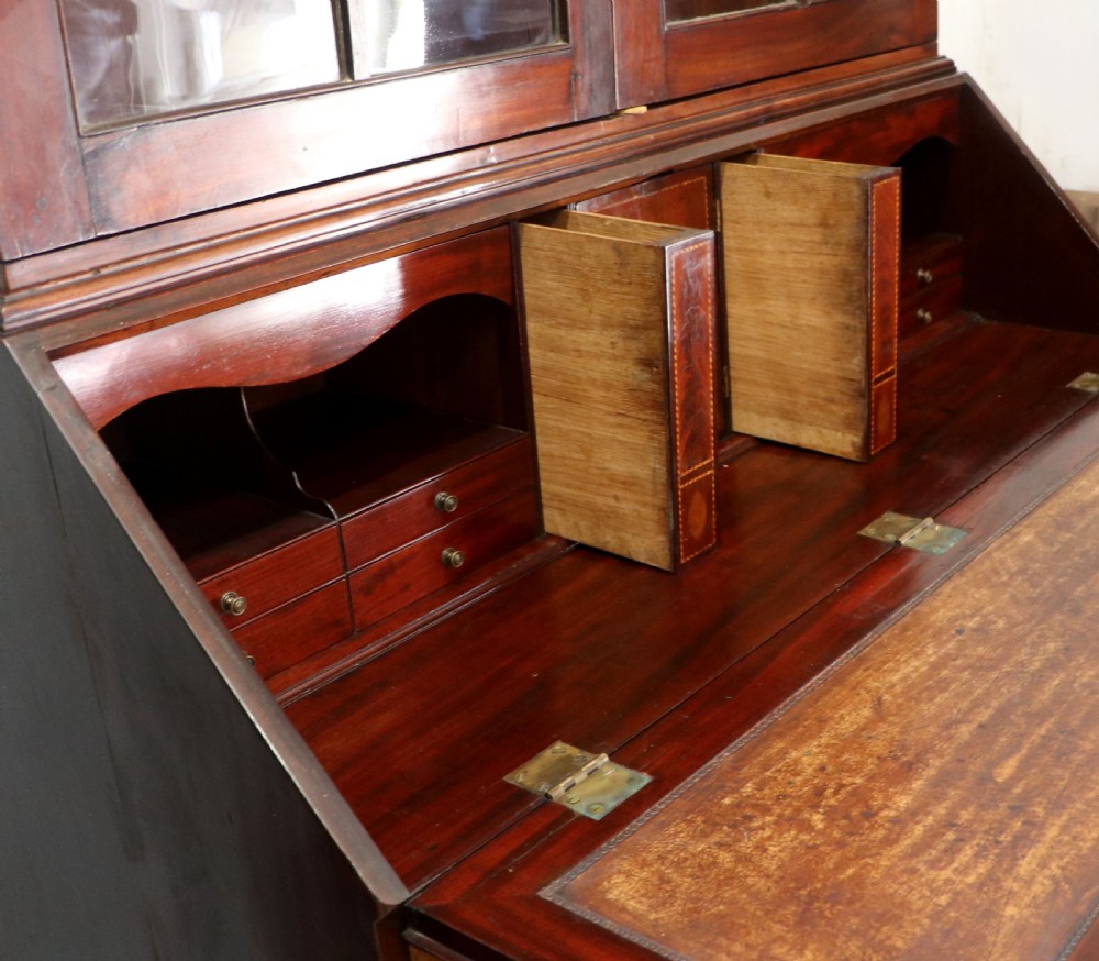 Late eighteenth-century mahogany bureau bookcase with an upper glazed cabinet featuring geometric astragal bars, an open fall-front writing surface, and lower drawers with brass handles. View XXIII