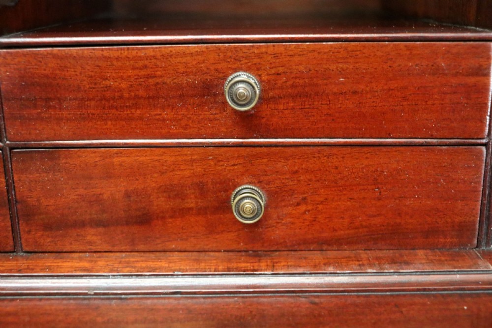 Late eighteenth-century mahogany bureau bookcase with an upper glazed cabinet featuring geometric astragal bars, an open fall-front writing surface, and lower drawers with brass handles. View XXV