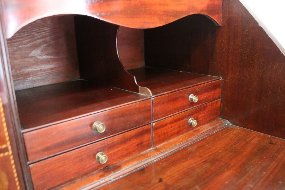 Late eighteenth-century mahogany bureau bookcase with an upper glazed cabinet featuring geometric astragal bars, an open fall-front writing surface, and lower drawers with brass handles. View XXVI