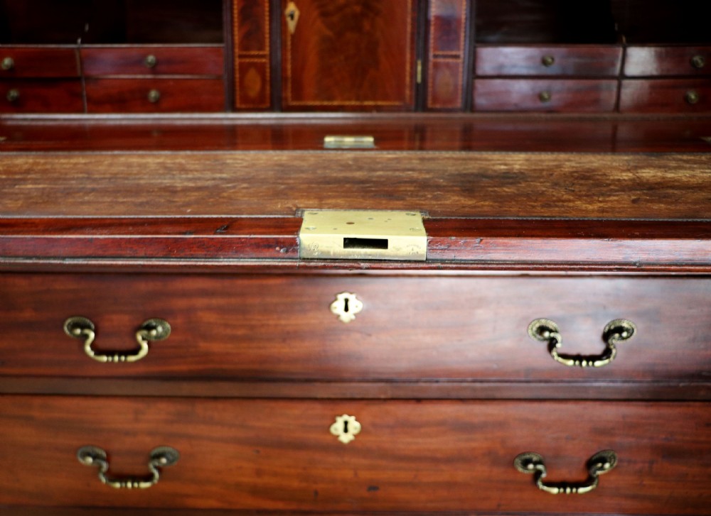 Late eighteenth-century mahogany bureau bookcase with an upper glazed cabinet featuring geometric astragal bars, an open fall-front writing surface, and lower drawers with brass handles. View XXVII