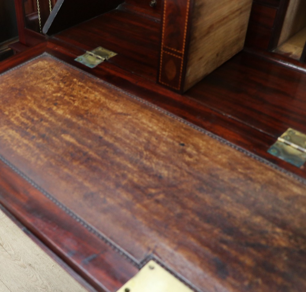 Late eighteenth-century mahogany bureau bookcase with an upper glazed cabinet featuring geometric astragal bars, an open fall-front writing surface, and lower drawers with brass handles. View XXVIII