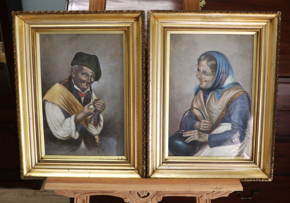 A pair of framed Italian oil portraits depicting an elderly man smoking a pipe and an elderly woman wearing a blue headscarf, both set in matching giltwood frames. View III