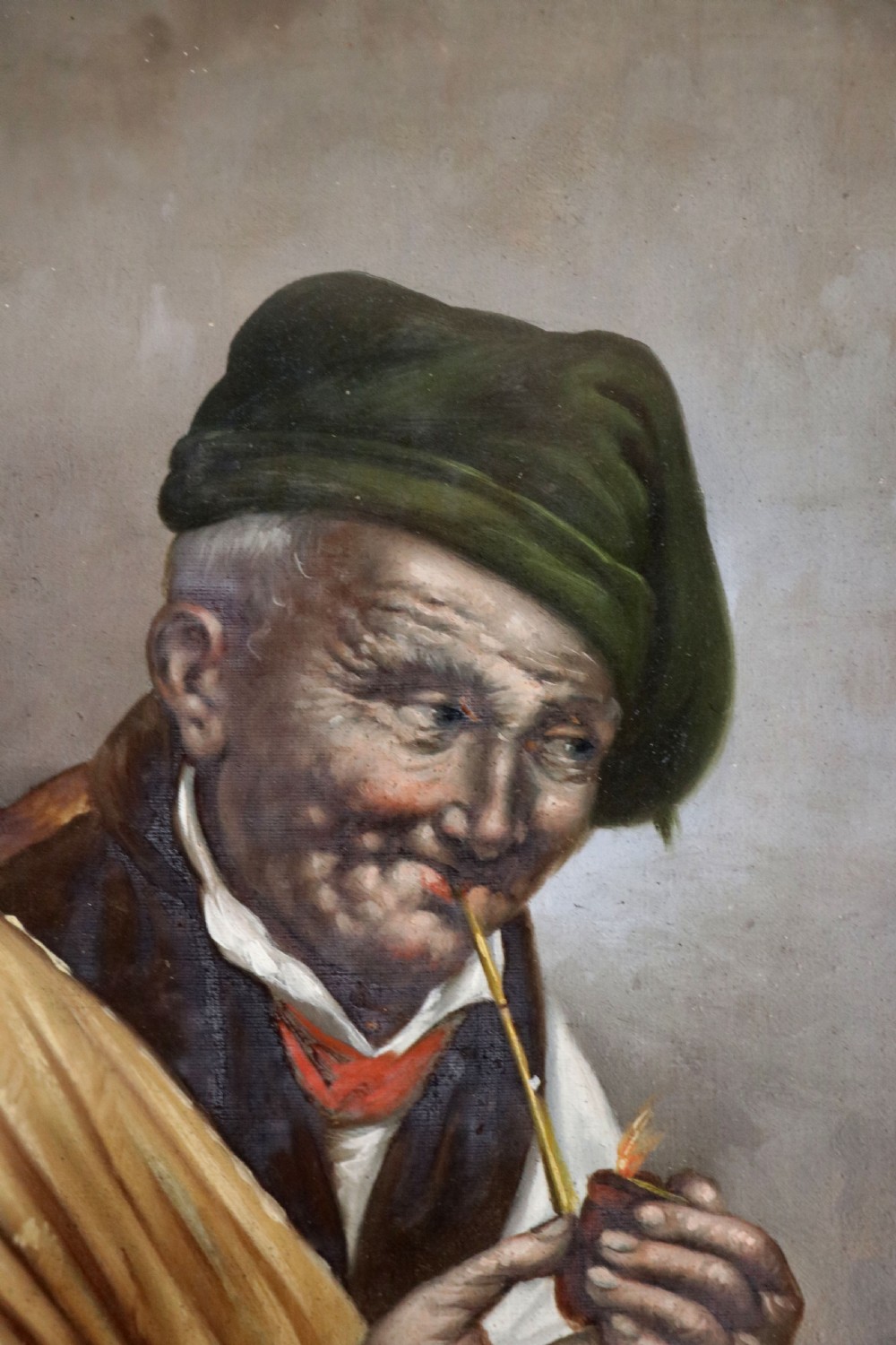 A pair of framed Italian oil portraits depicting an elderly man smoking a pipe and an elderly woman wearing a blue headscarf, both set in matching giltwood frames. View VI