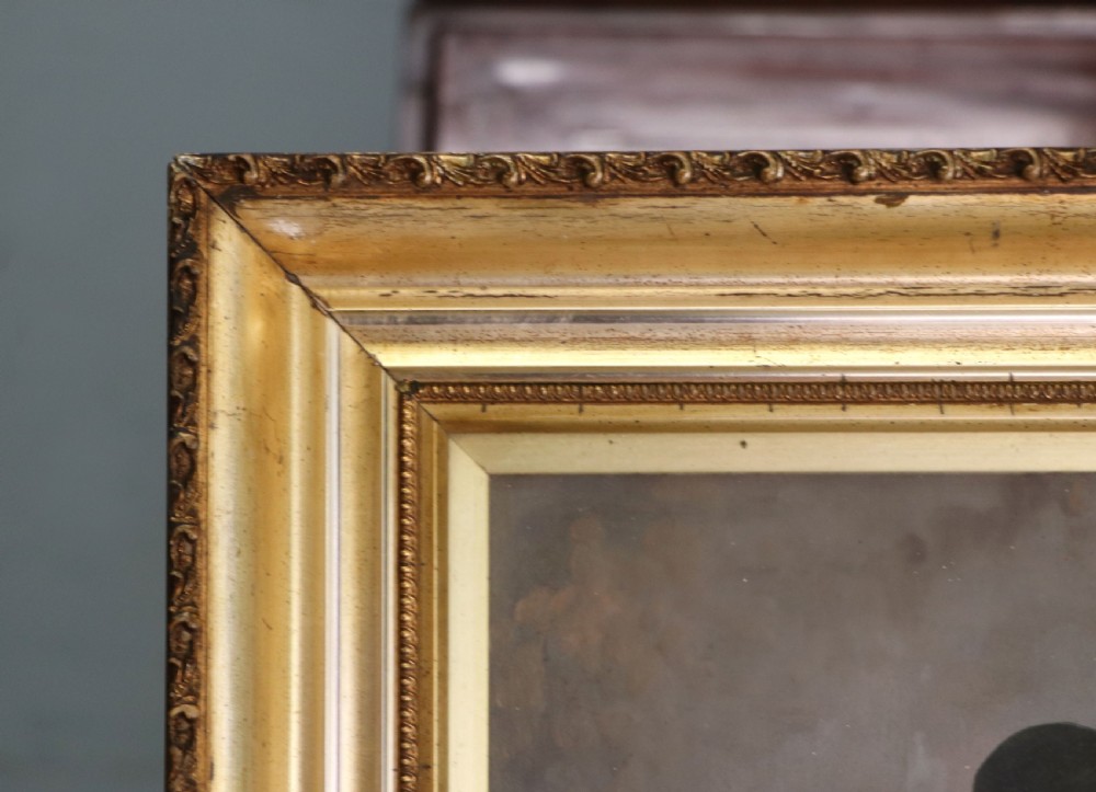 A pair of framed Italian oil portraits depicting an elderly man smoking a pipe and an elderly woman wearing a blue headscarf, both set in matching giltwood frames. View VII