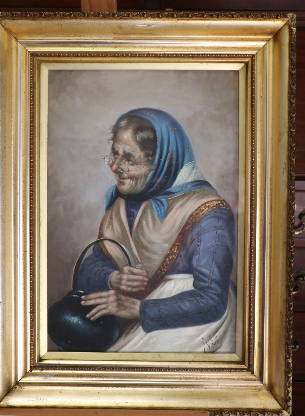 A pair of framed Italian oil portraits depicting an elderly man smoking a pipe and an elderly woman wearing a blue headscarf, both set in matching giltwood frames. View IX