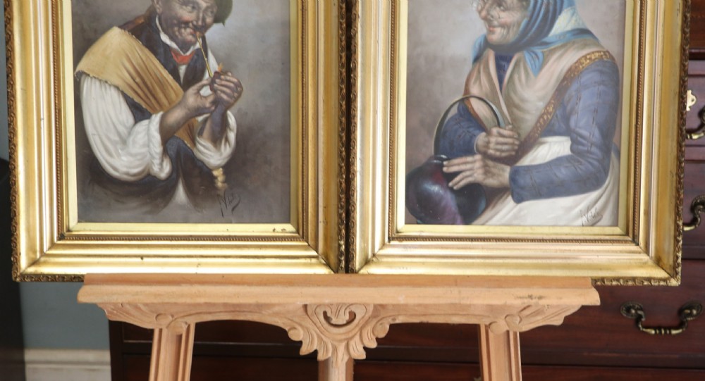 A pair of framed Italian oil portraits depicting an elderly man smoking a pipe and an elderly woman wearing a blue headscarf, both set in matching giltwood frames. View XVI