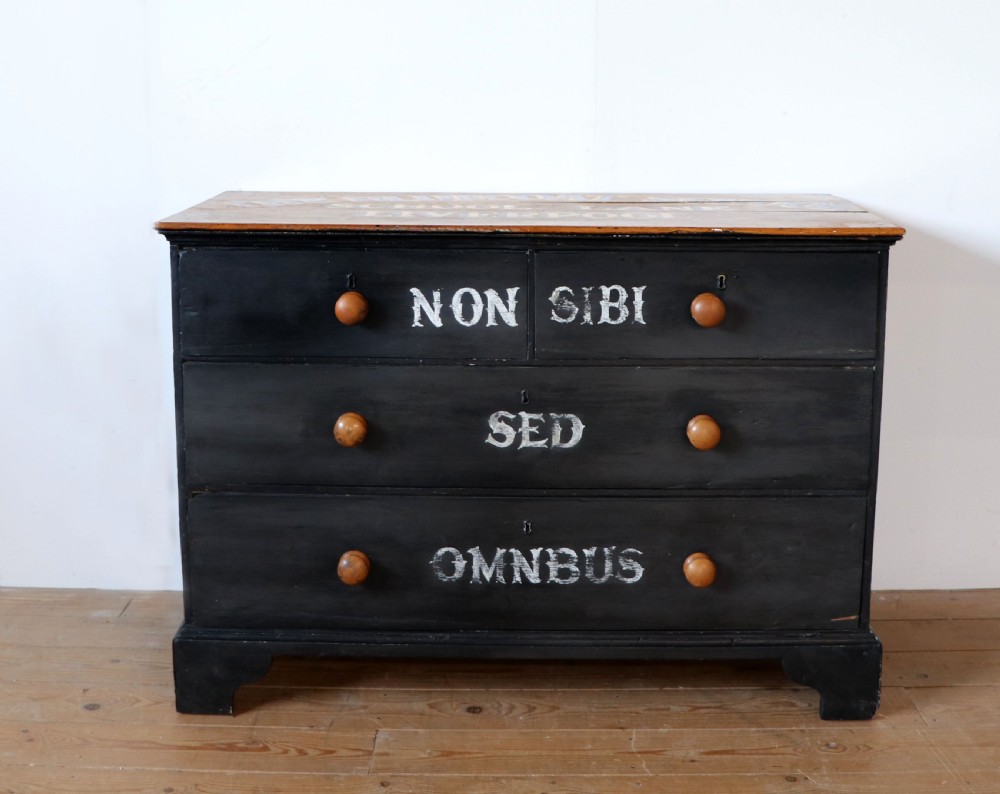 A Victorian black painted pine chest of drawers featuring a natural timber top with hand-painted lettering and turned wooden knobs. View II