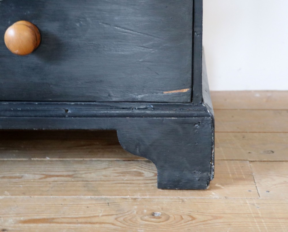 A Victorian black painted pine chest of drawers featuring a natural timber top with hand-painted lettering and turned wooden knobs. View XX