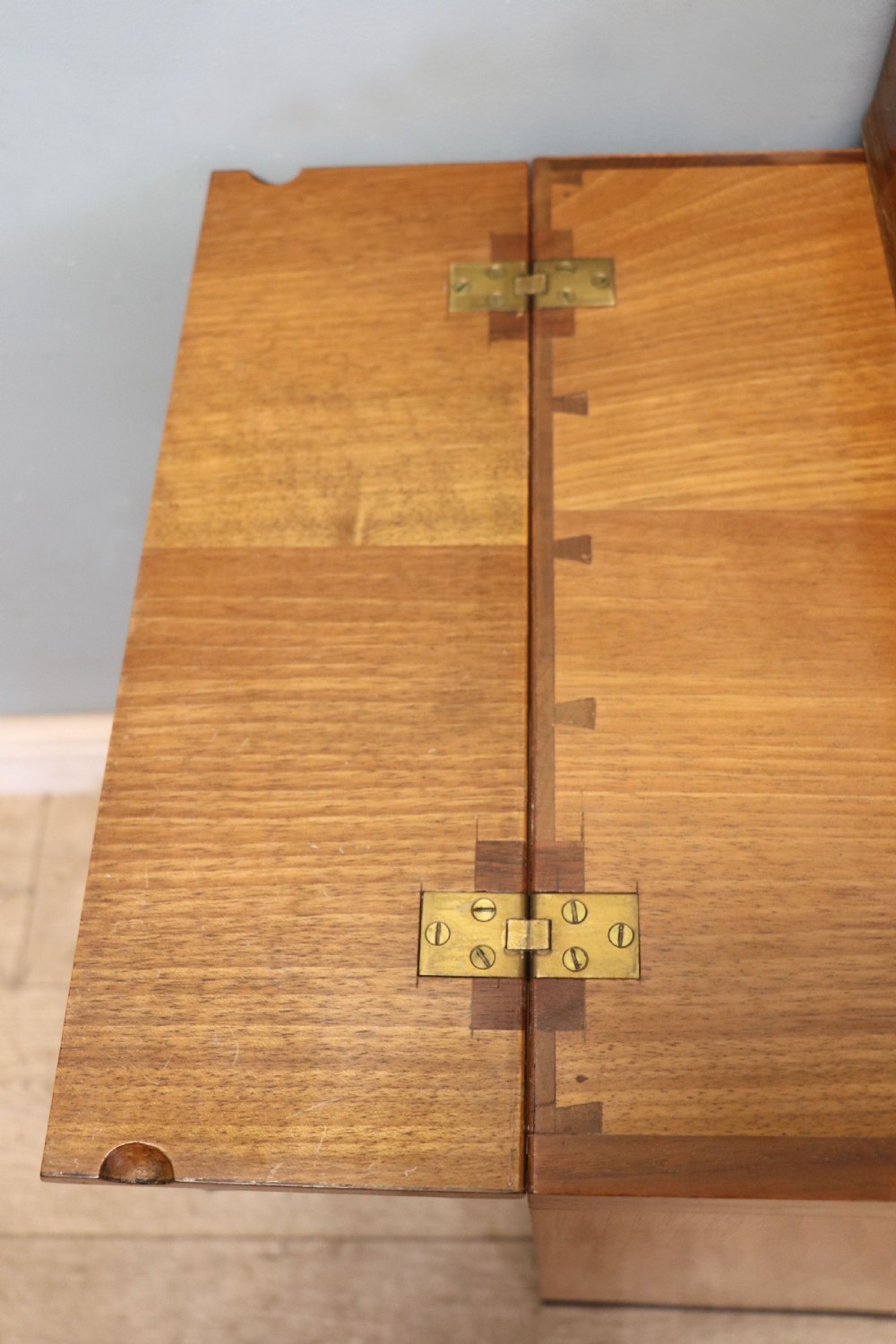 An Art Deco walnut pedestal desk featuring a glass-topped centre writing surface and hinged fold-out side flaps supported by twin cabinet bases. View XII