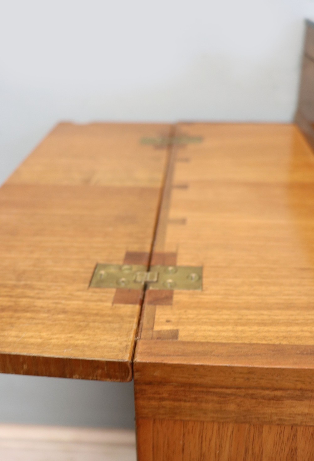 An Art Deco walnut pedestal desk featuring a glass-topped centre writing surface and hinged fold-out side flaps supported by twin cabinet bases. View XIII