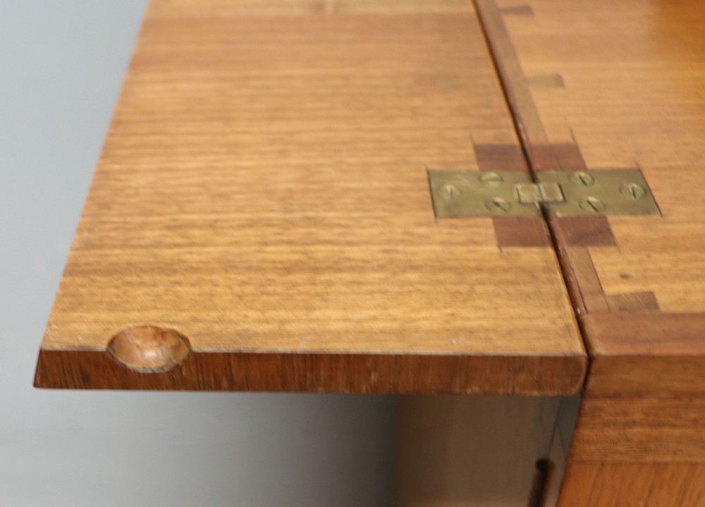 An Art Deco walnut pedestal desk featuring a glass-topped centre writing surface and hinged fold-out side flaps supported by twin cabinet bases. View XIV