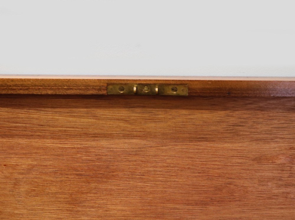 An Art Deco walnut pedestal desk featuring a glass-topped centre writing surface and hinged fold-out side flaps supported by twin cabinet bases. View XXII