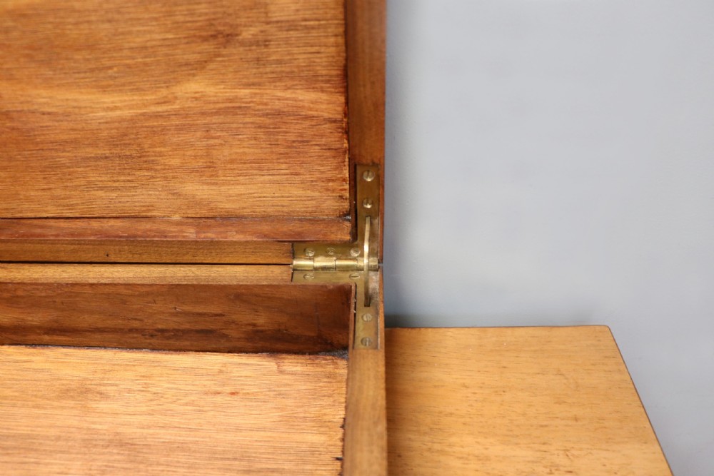 An Art Deco walnut pedestal desk featuring a glass-topped centre writing surface and hinged fold-out side flaps supported by twin cabinet bases. View XXVI