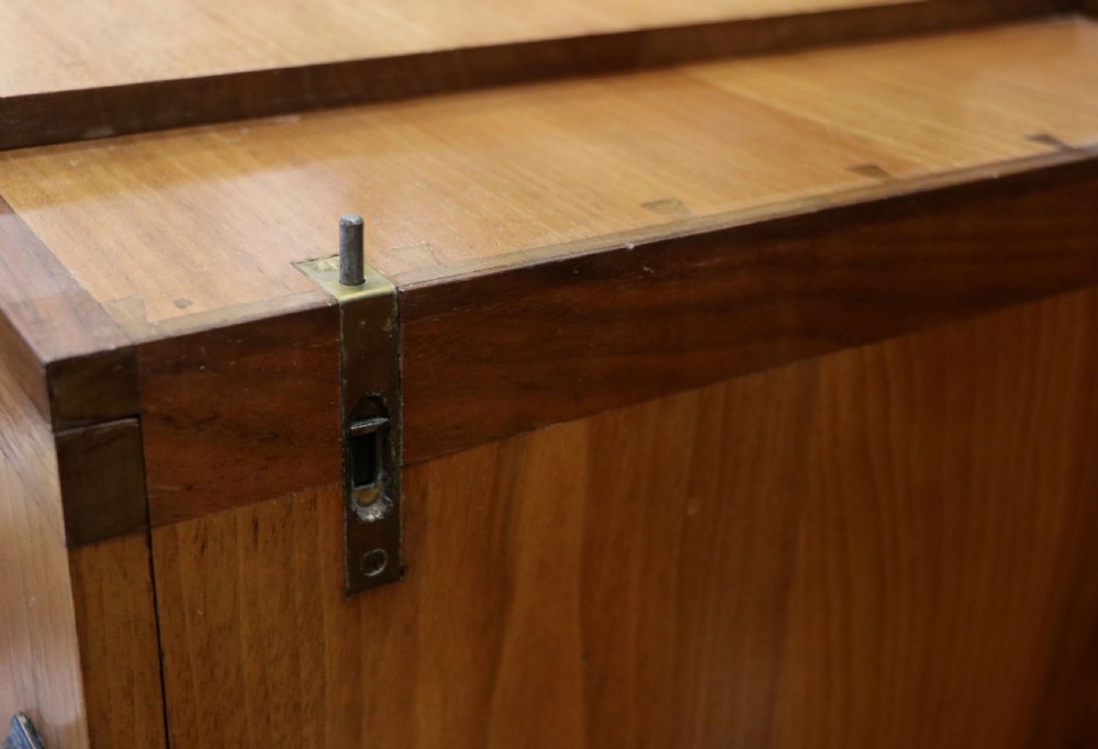 An Art Deco walnut pedestal desk featuring a glass-topped centre writing surface and hinged fold-out side flaps supported by twin cabinet bases. View XXIX