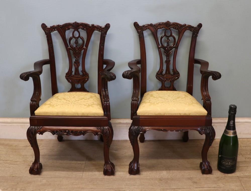 A pair of Georgian revival style child carver chairs made of polished dark mahogany with pierced splat backs, cabriole legs, ball and claw feet, and yellow damask upholstered seats. View III