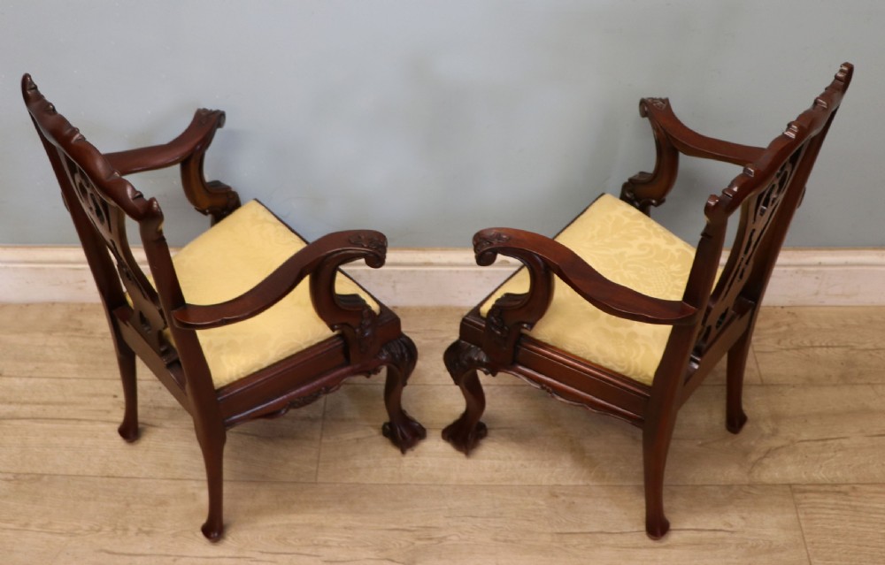 A pair of Georgian revival style child carver chairs made of polished dark mahogany with pierced splat backs, cabriole legs, ball and claw feet, and yellow damask upholstered seats. View VII