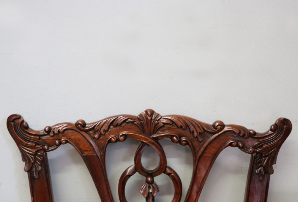 A pair of Georgian revival style child carver chairs made of polished dark mahogany with pierced splat backs, cabriole legs, ball and claw feet, and yellow damask upholstered seats. View XI
