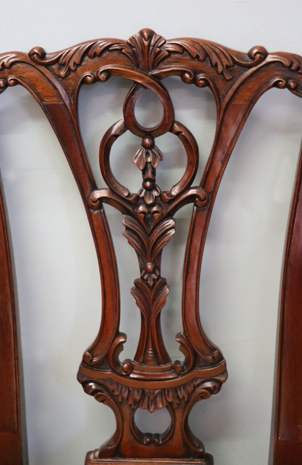 A pair of Georgian revival style child carver chairs made of polished dark mahogany with pierced splat backs, cabriole legs, ball and claw feet, and yellow damask upholstered seats. View XII