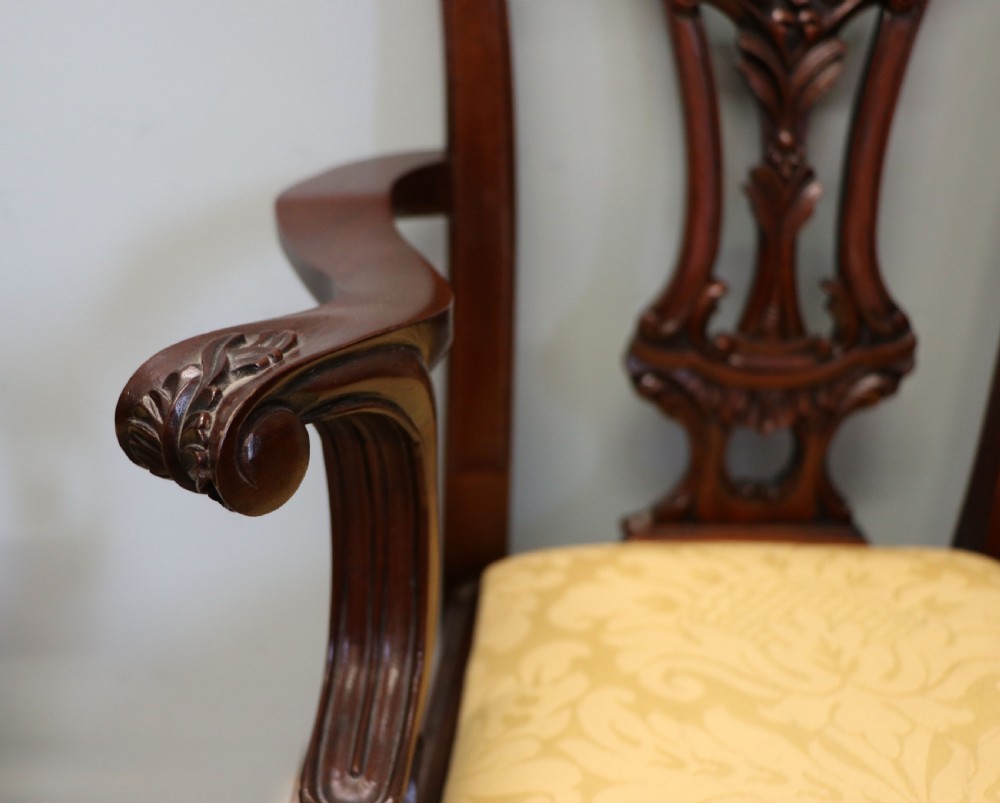 A pair of Georgian revival style child carver chairs made of polished dark mahogany with pierced splat backs, cabriole legs, ball and claw feet, and yellow damask upholstered seats. View XIII