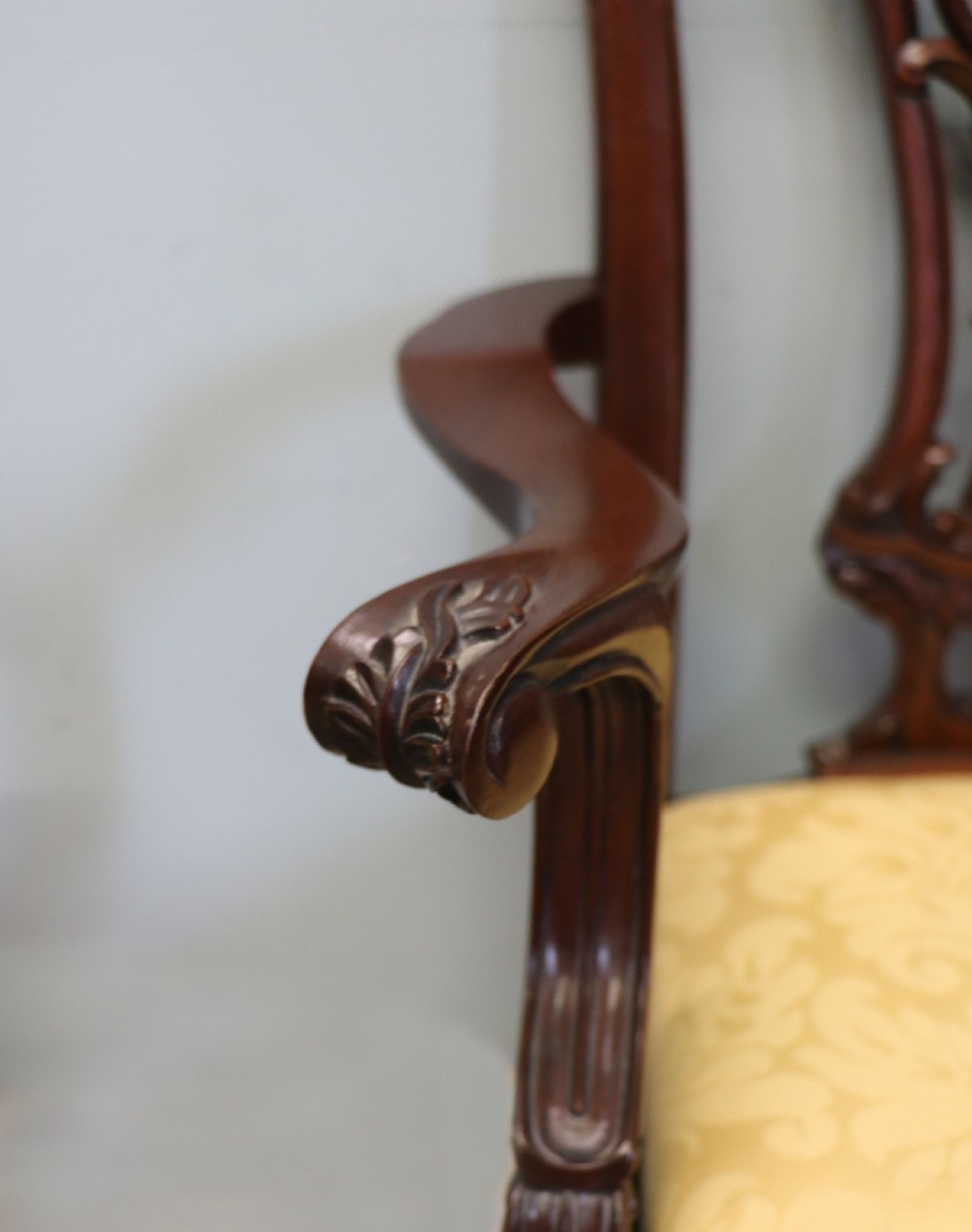 A pair of Georgian revival style child carver chairs made of polished dark mahogany with pierced splat backs, cabriole legs, ball and claw feet, and yellow damask upholstered seats. View XIV