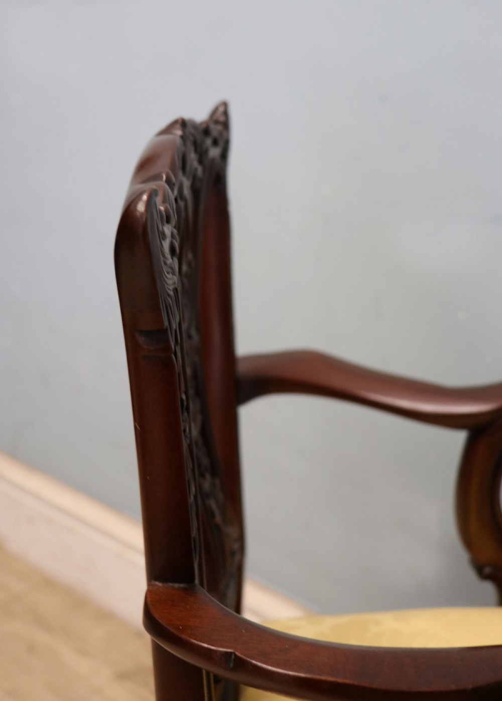 A pair of Georgian revival style child carver chairs made of polished dark mahogany with pierced splat backs, cabriole legs, ball and claw feet, and yellow damask upholstered seats. View XV