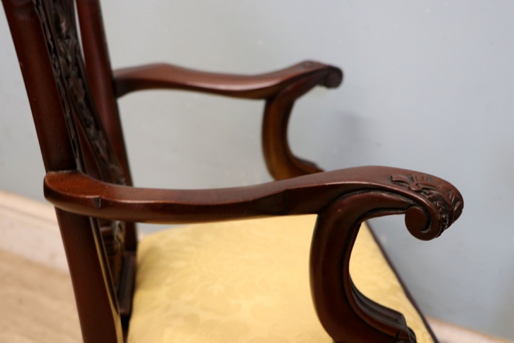 A pair of Georgian revival style child carver chairs made of polished dark mahogany with pierced splat backs, cabriole legs, ball and claw feet, and yellow damask upholstered seats. View XVII