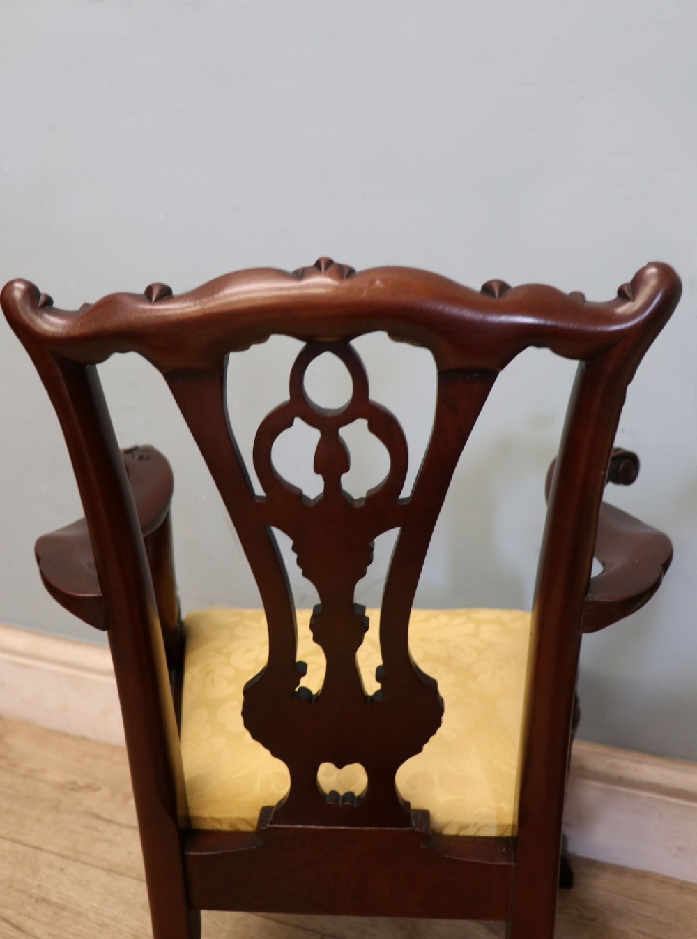 A pair of Georgian revival style child carver chairs made of polished dark mahogany with pierced splat backs, cabriole legs, ball and claw feet, and yellow damask upholstered seats. View XIX