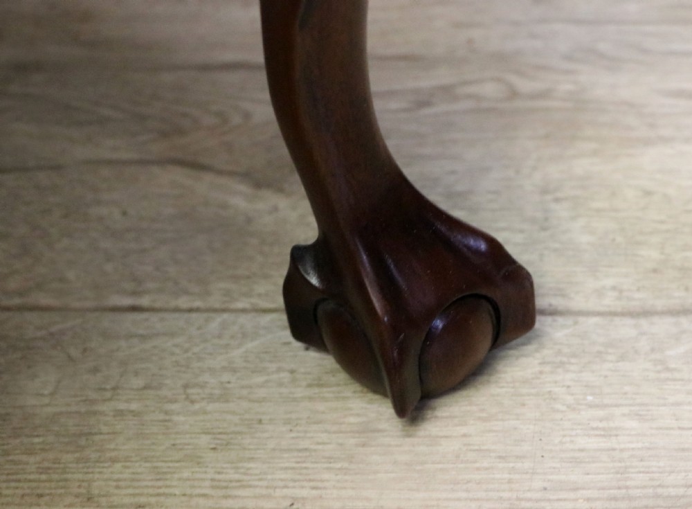 A pair of Georgian revival style child carver chairs made of polished dark mahogany with pierced splat backs, cabriole legs, ball and claw feet, and yellow damask upholstered seats. View XXIV