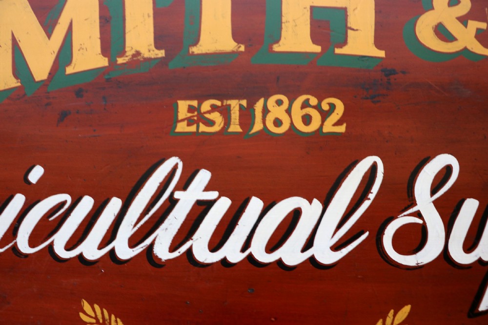 A Victorian red painted pine chest of four drawers featuring white, yellow, and green hand-painted commercial sign-writing and cut glass knobs. View VIII