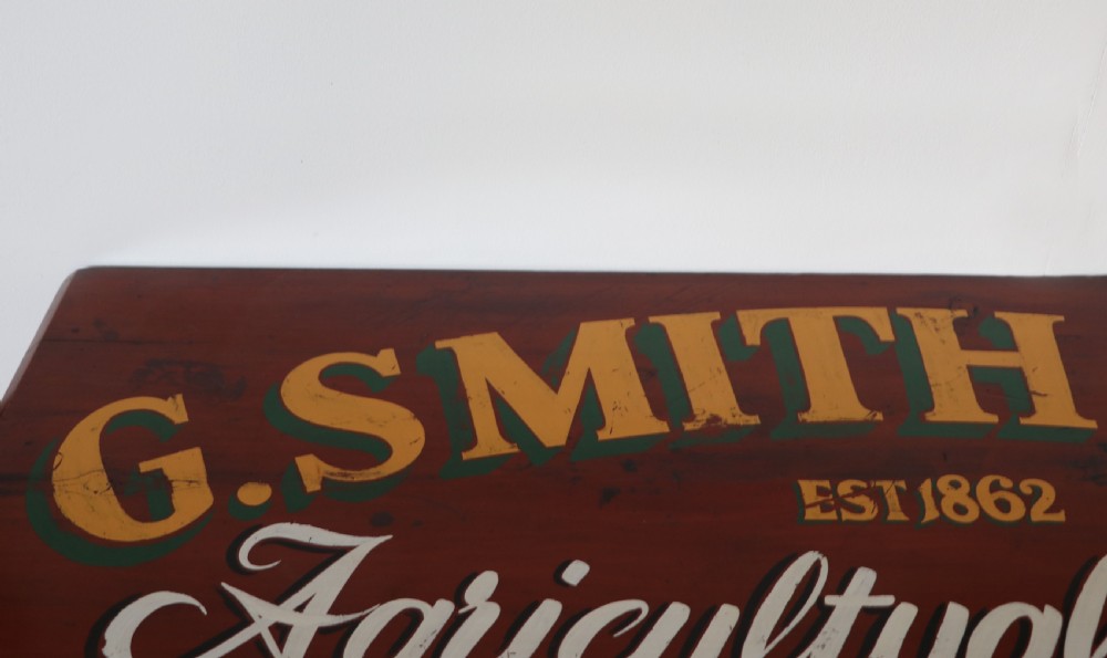 A Victorian red painted pine chest of four drawers featuring white, yellow, and green hand-painted commercial sign-writing and cut glass knobs. View IX